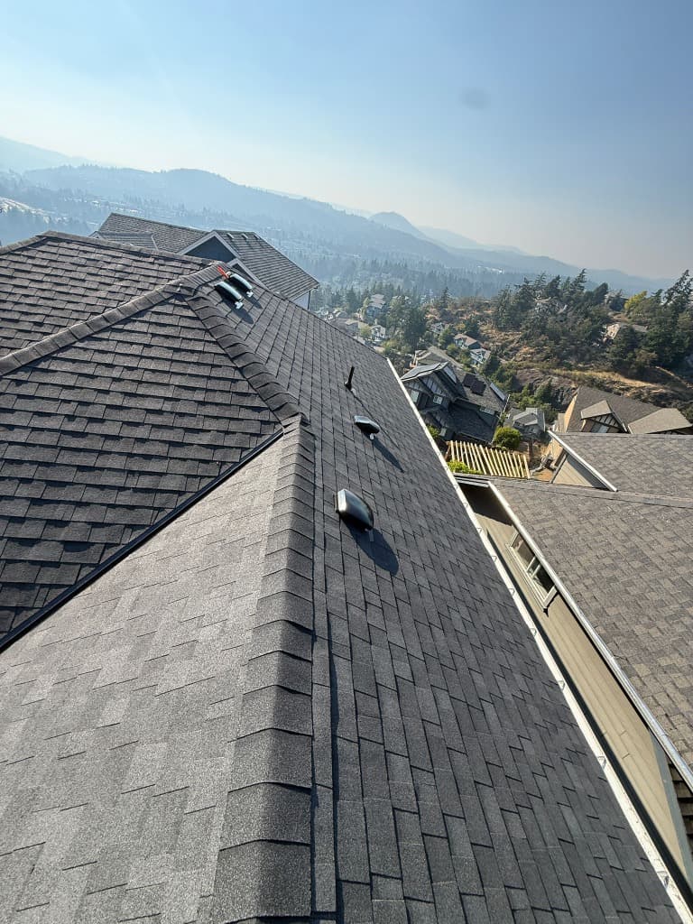 Shingle roof installation on hillside home