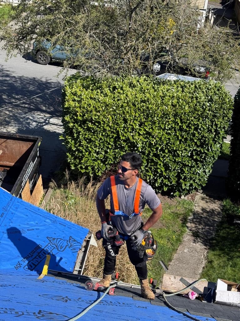 Vision Roofing crew member with safety gear on site