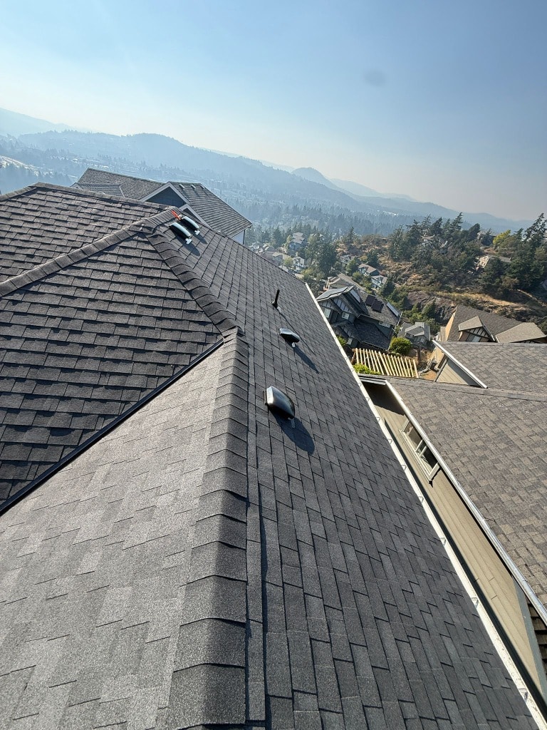 Shingle roof installation on hillside home